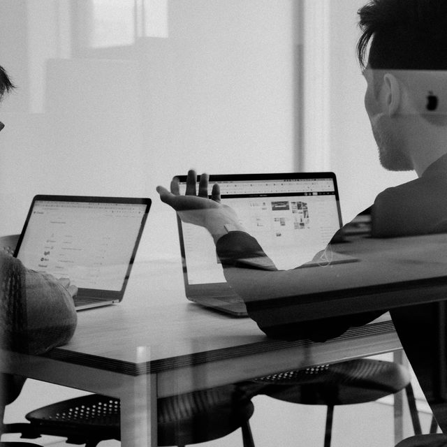 Analysts reviewing survey results at a laptop